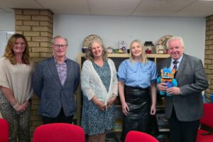 Assistant Provincial Grand Master Steve Attwood, and Mark Harwood standing with staff members at the Women's Aid Centre in Luton